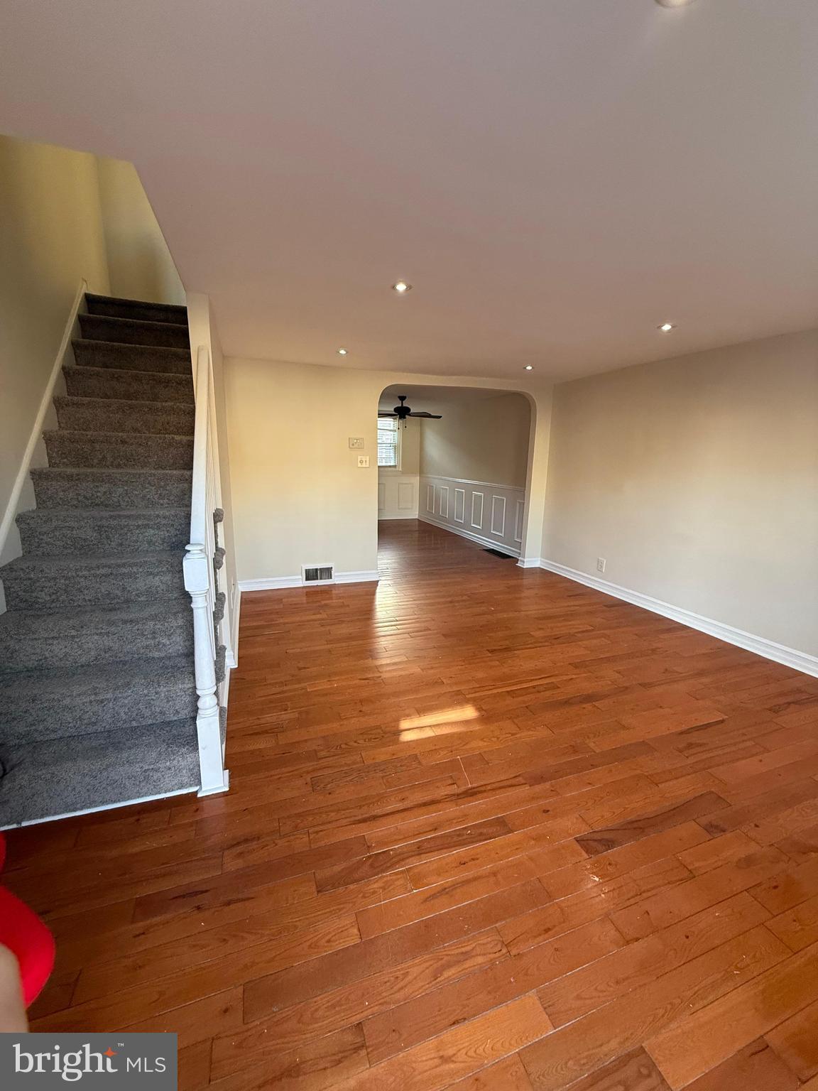 a view of a kitchen with an empty space and wooden floor