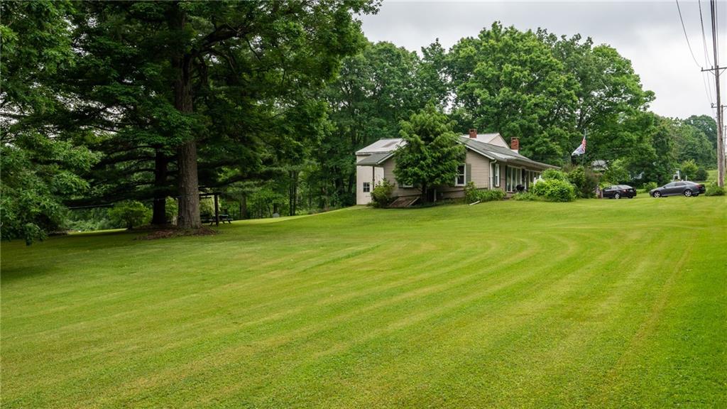 1049 Branchton Road Boyers, PA 16020 - Photo 21 of 22 a front view of a house with a yard and trees