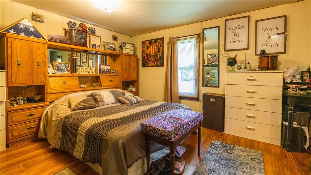 1049 Branchton Road Boyers, PA 16020 - Photo 8 of 22 a bedroom with a bed and wooden floor