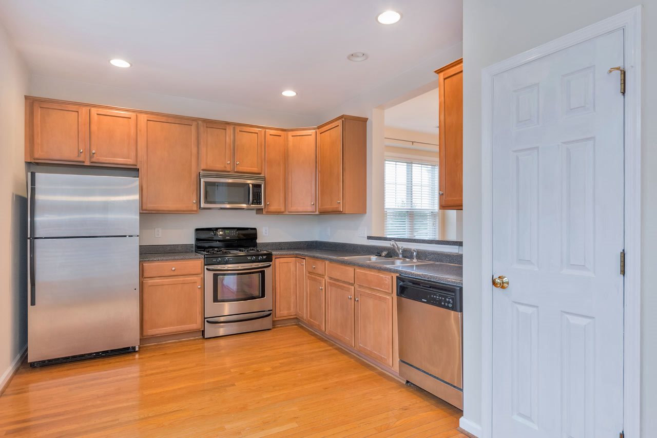 1319 Stoney Ridge Road Charlottesville, VA 22902 - Photo 6 of 17 a kitchen with granite countertop stainless steel appliances and wooden cabinets