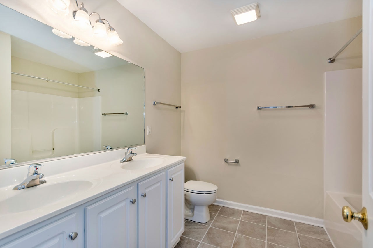 1319 Stoney Ridge Road Charlottesville, VA 22902 - Photo 10 of 17 a bathroom with a double vanity sink mirror and toilet