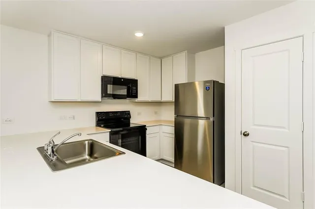 a kitchen with a refrigerator sink and microwave