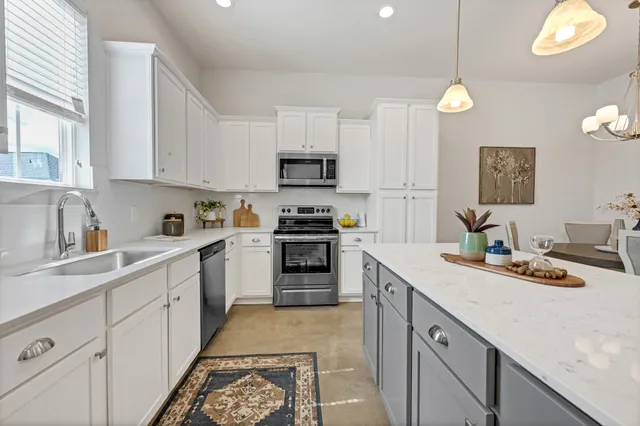 a kitchen with a sink cabinets and window