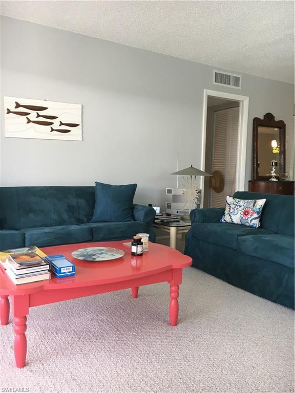 4140 Crayton Road, Unit D6 Naples, FL 34103 - Photo 3 of 14 a bedroom with furniture and a bed