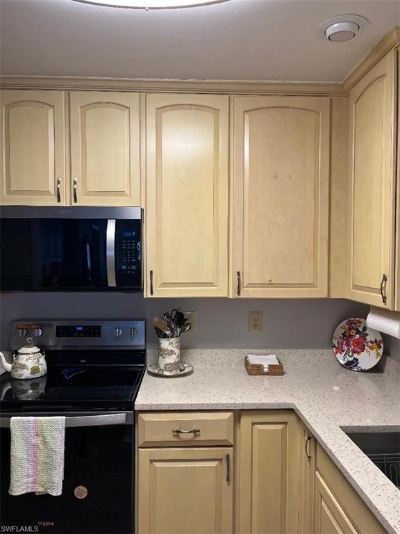 4140 Crayton Road, Unit D6 Naples, FL 34103 - Photo 6 of 14 a kitchen with a sink and cabinets