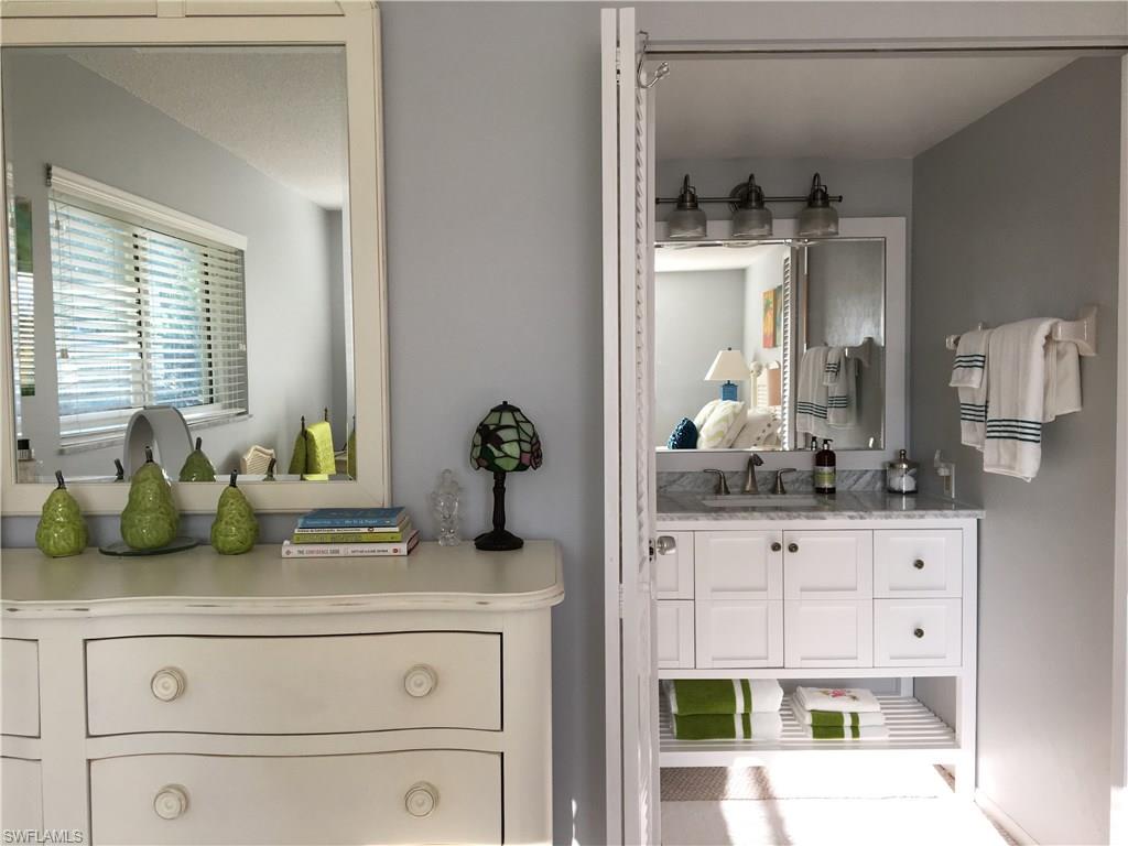 4140 Crayton Road, Unit D6 Naples, FL 34103 - Photo 7 of 14 a bathroom with a sink and a mirror