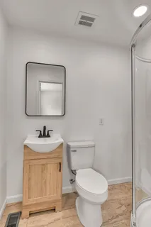 a bathroom with a shower and a toilet