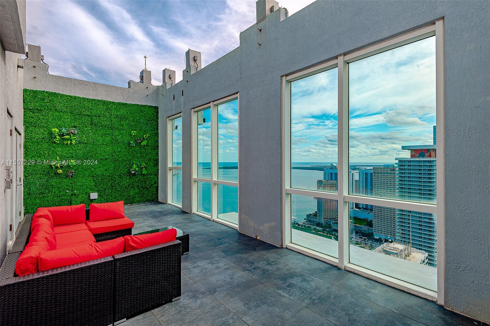 244 Biscayne Boulevard, Unit UPH4907 Miami, FL 33132 - Photo 18 of 38 a view of a porch with furniture and a yard