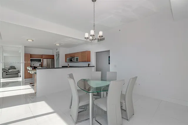 a view of a dining room with furniture and a chandelier