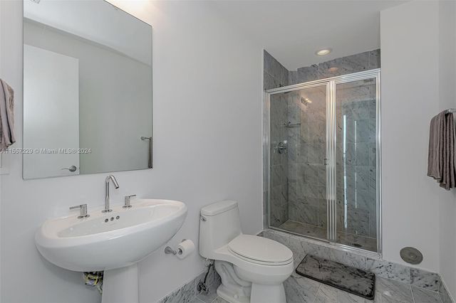 a bathroom with a sink toilet and shower