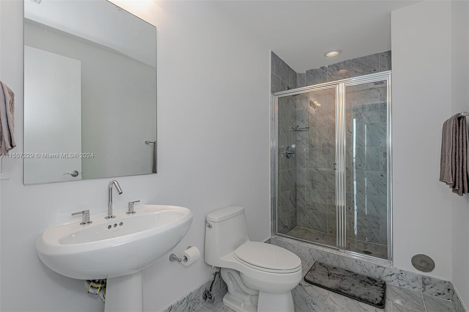244 Biscayne Boulevard, Unit UPH4907 Miami, FL 33132 - Photo 29 of 38 a bathroom with a sink toilet and shower