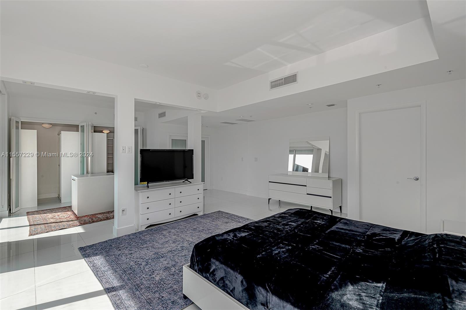 244 Biscayne Boulevard, Unit UPH4907 Miami, FL 33132 - Photo 31 of 38 a bedroom with bed and flat screen tv