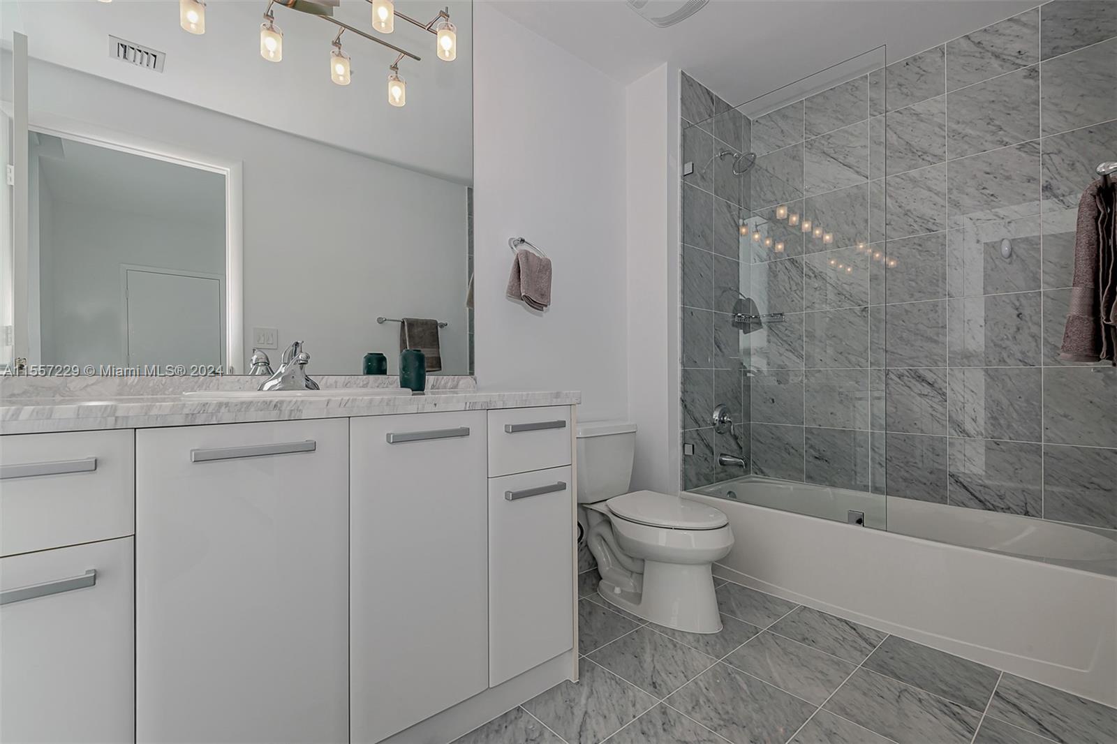 244 Biscayne Boulevard, Unit UPH4907 Miami, FL 33132 - Photo 36 of 38 a bathroom with a sink toilet and shower