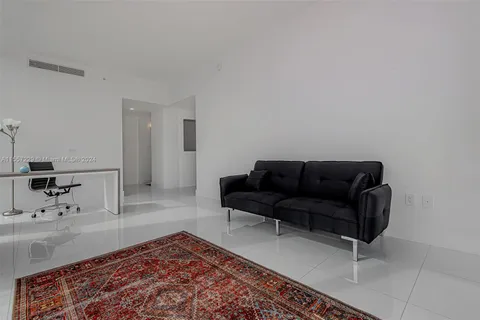 a living room with a couch and a rug