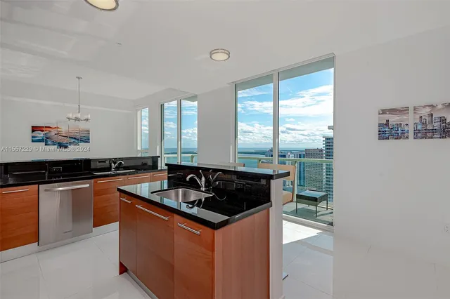 a kitchen with granite countertop a sink and a stove