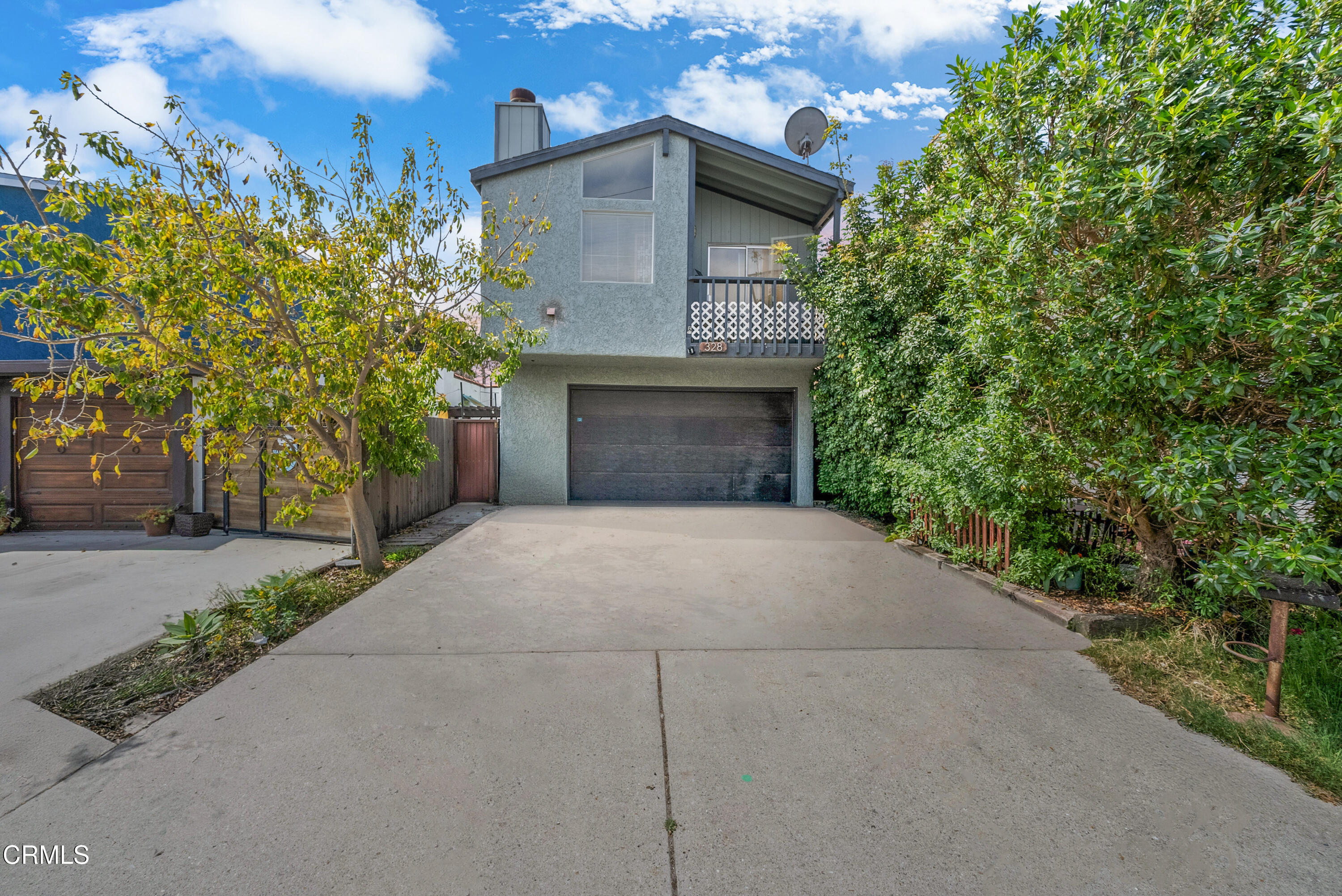 a front view of a house with yard garage and garage