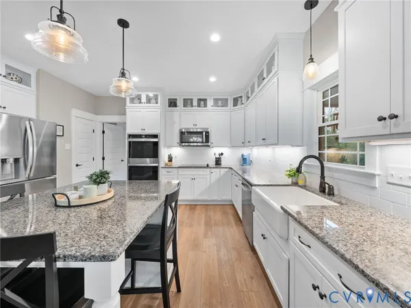 a bedroom with a bed window and a flat screen tv
