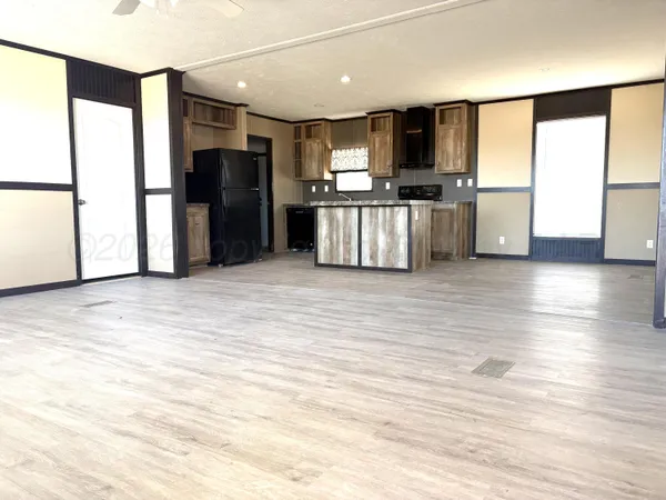 a large kitchen with stainless steel appliances a refrigerator and a stove top oven