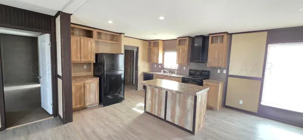 a kitchen with stainless steel appliances granite countertop a refrigerator a sink and a stove