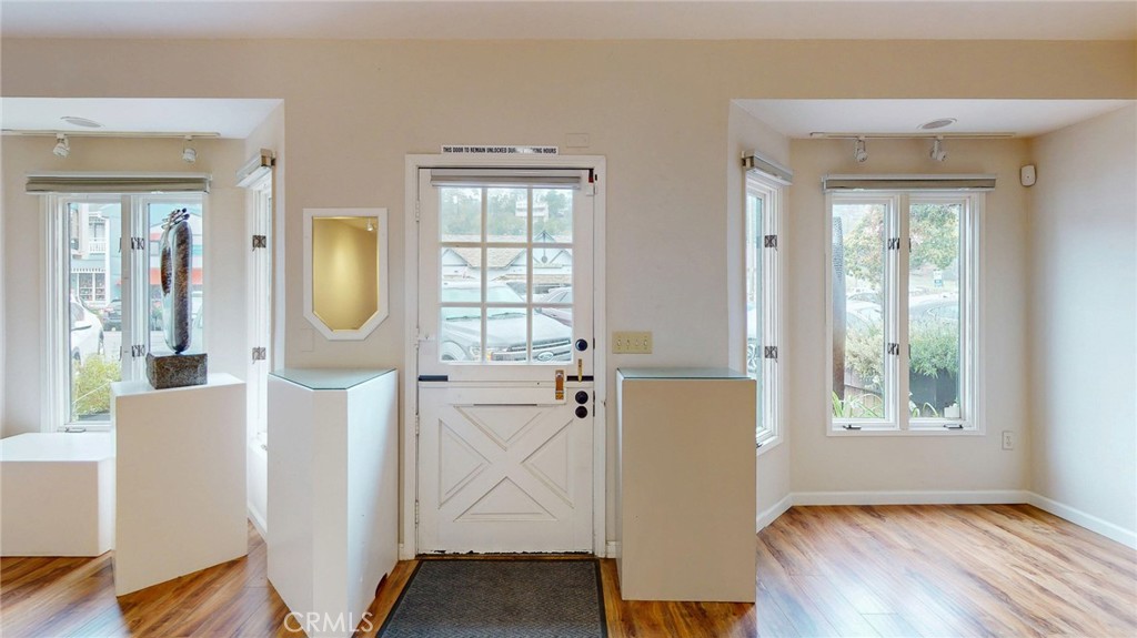 786 Main Street Cambria, CA 93428 - Photo 19 of 36 a view of a room with wooden floor and windows