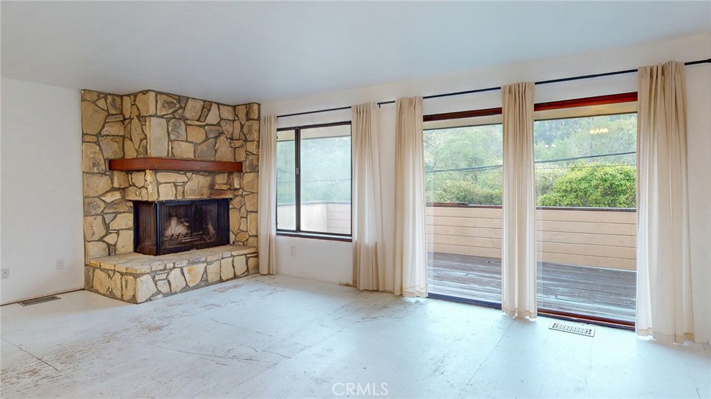 786 Main Street Cambria, CA 93428 - Photo 2 of 36 a view of an empty room with a fireplace and a window