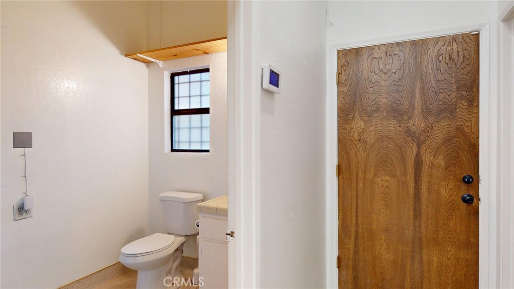 786 Main Street Cambria, CA 93428 - Photo 28 of 36 a white toilet sitting next to a bathroom sink