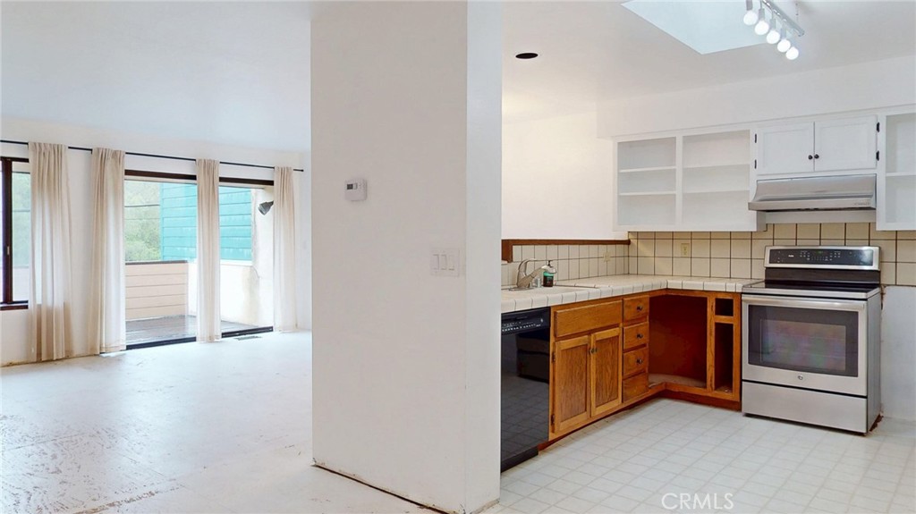786 Main Street Cambria, CA 93428 - Photo 3 of 36 a kitchen with stainless steel appliances granite countertop a stove and a refrigerator