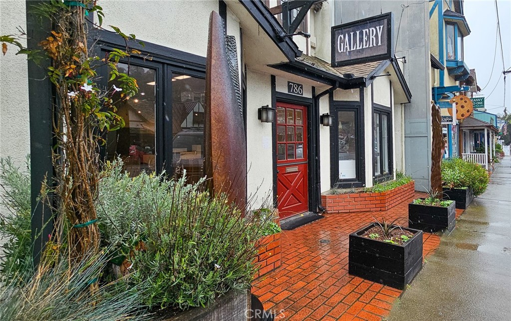 786 Main Street Cambria, CA 93428 - Photo 33 of 36 a front view of a house with lots of green space