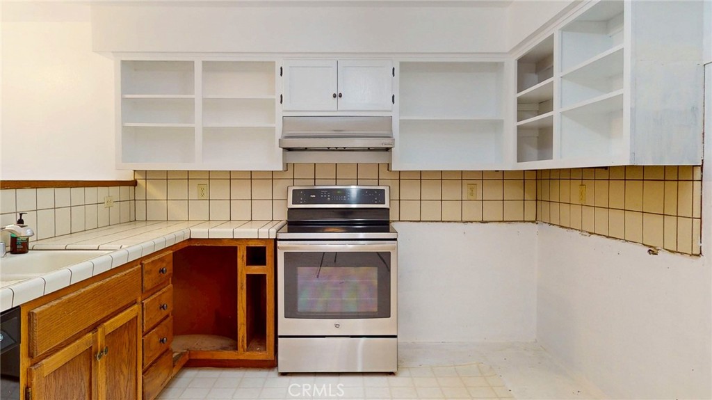 786 Main Street Cambria, CA 93428 - Photo 5 of 36 a kitchen with stainless steel appliances granite countertop a stove and a refrigerator