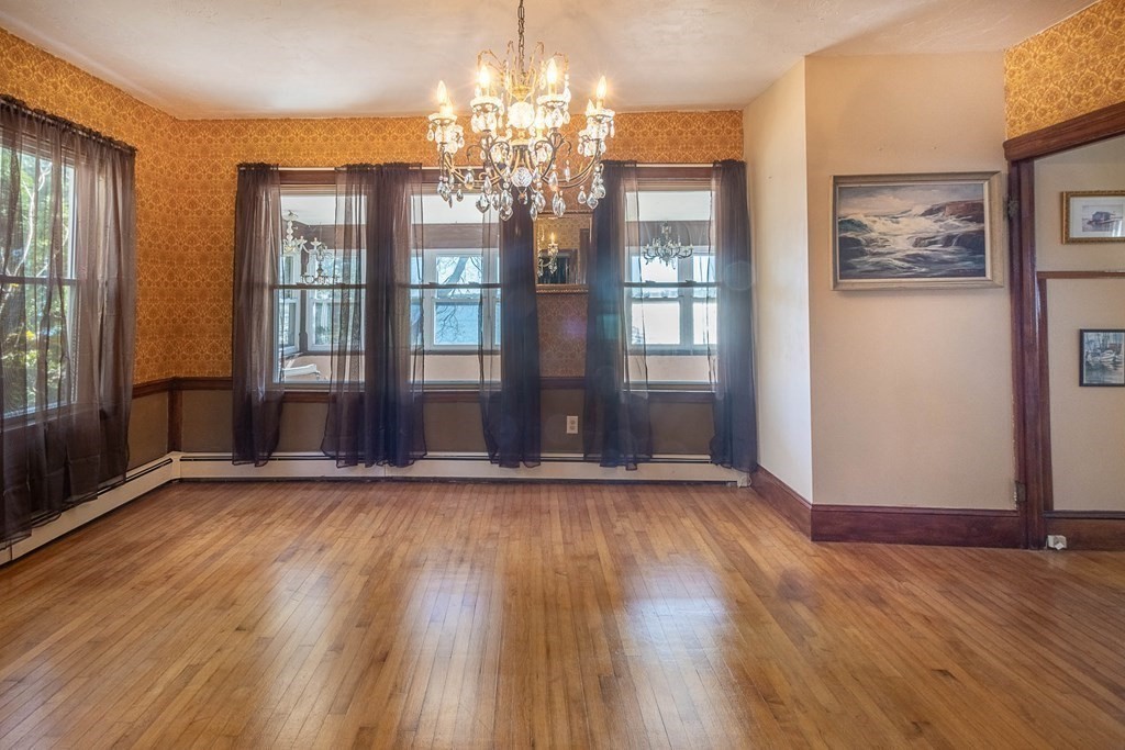 91 Edgewater Road Hull, MA 02045 - Photo 11 of 41 a view of an empty room with wooden floor and a window
