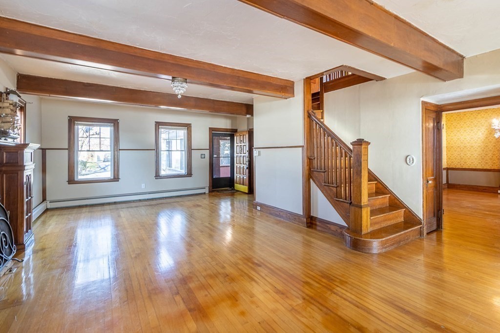 91 Edgewater Road Hull, MA 02045 - Photo 16 of 41 a view of a livingroom with wooden floor and stairs