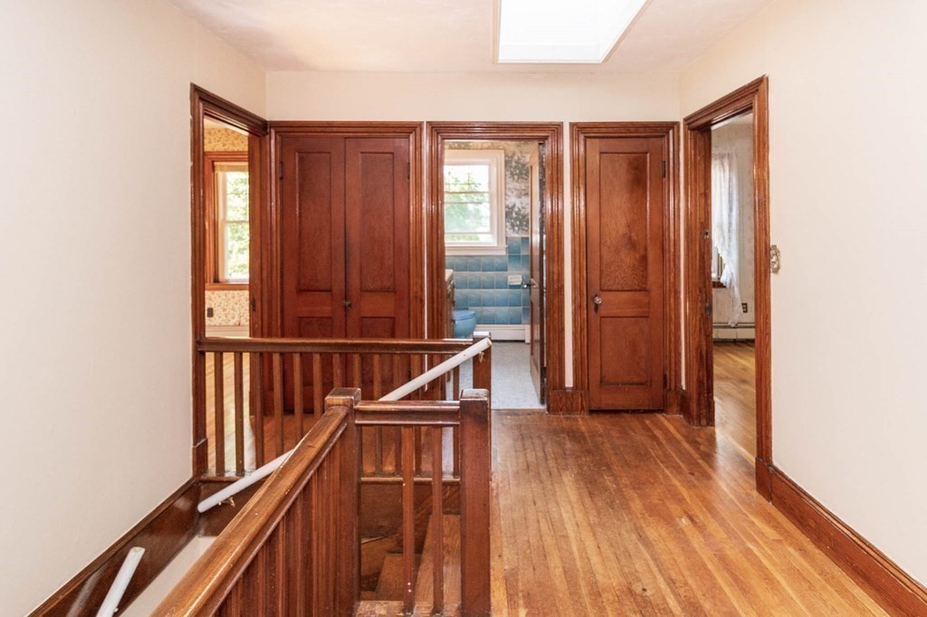 91 Edgewater Road Hull, MA 02045 - Photo 19 of 41 a view of a hallway with wooden floor and staircase