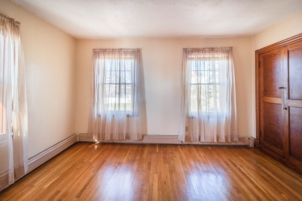 91 Edgewater Road Hull, MA 02045 - Photo 21 of 41 an empty room with wooden floor and windows