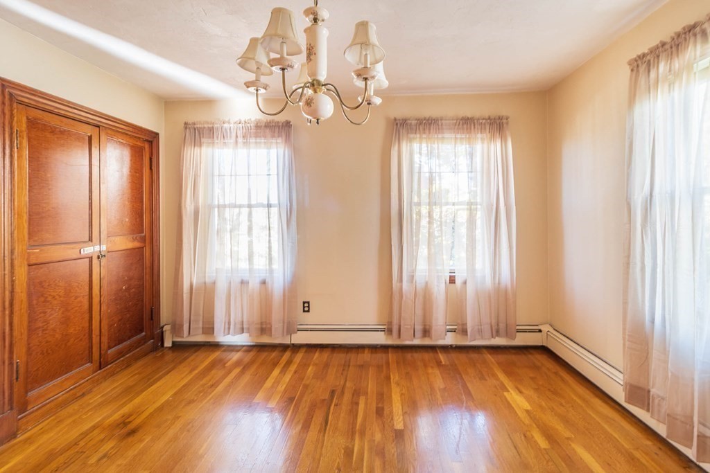 91 Edgewater Road Hull, MA 02045 - Photo 23 of 41 an empty room with wooden floor and windows