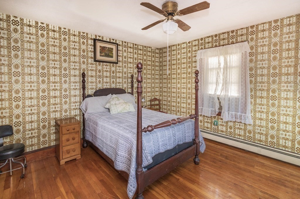 91 Edgewater Road Hull, MA 02045 - Photo 25 of 41 a bedroom with a bed and wooden floor