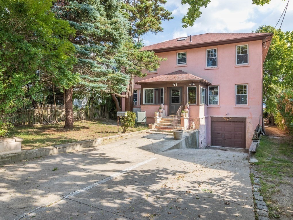 91 Edgewater Road Hull, MA 02045 - Photo 5 of 41 a front view of a house with a yard patio and fire pit