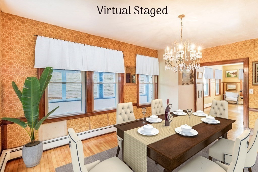 91 Edgewater Road Hull, MA 02045 - Photo 10 of 41 a view of a dining room with furniture a chandelier and large windows