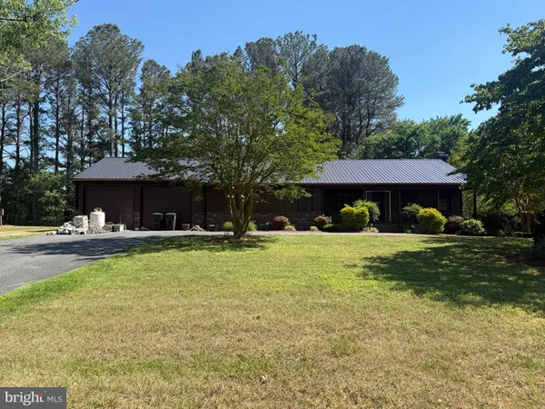 a front view of a house with swimming pool and furniture
