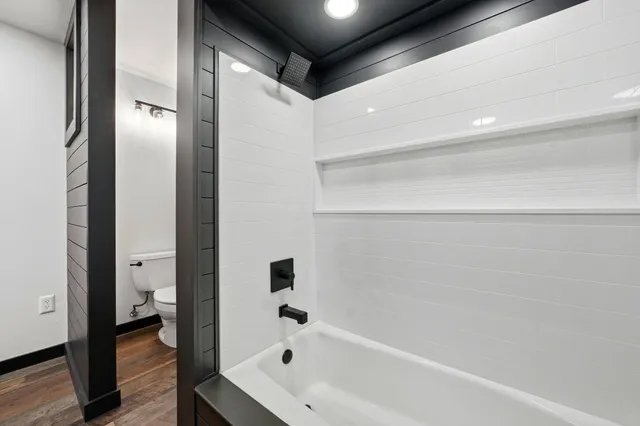 a bathroom with a bathtub and a shower