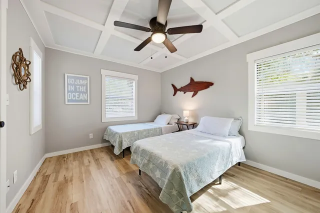 a bedroom with two beds and a window