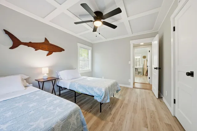a bedroom with two beds and a chandelier