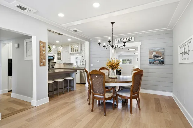 a view of a dining room with furniture and chandelier