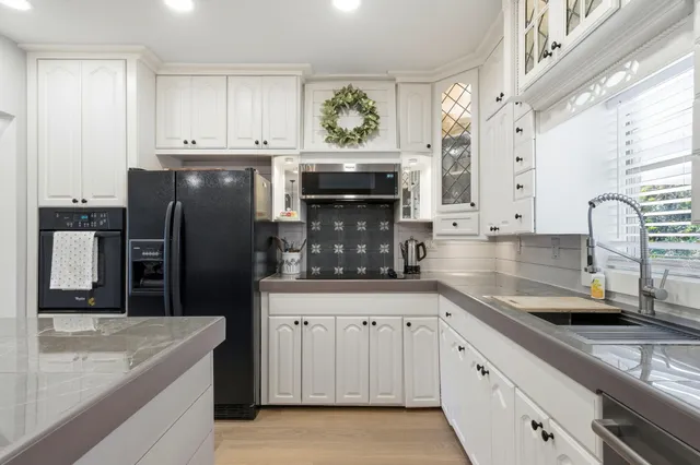 a kitchen with granite countertop a sink and stainless steel appliances