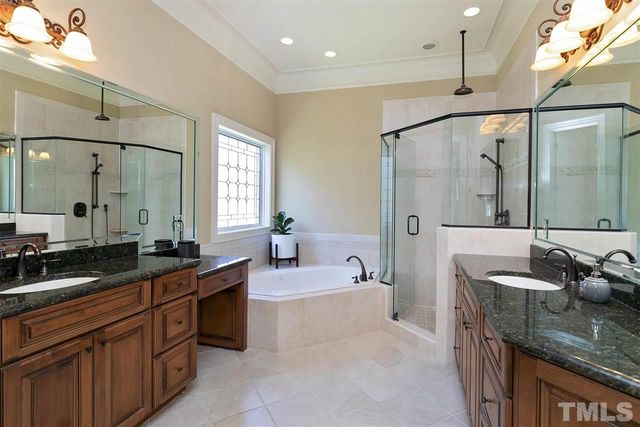 a spacious bathroom with a granite countertop sink mirror and bathtub