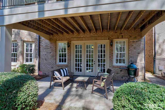 a view of a patio with table and chairs and potted plants