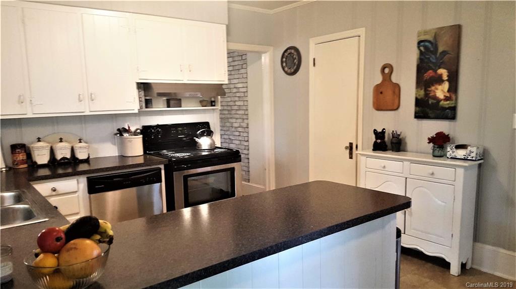 1654 Prince Road Columbus, NC 28722 - Photo 2 of 29 a kitchen with granite countertop a sink cabinets and stainless steel appliances