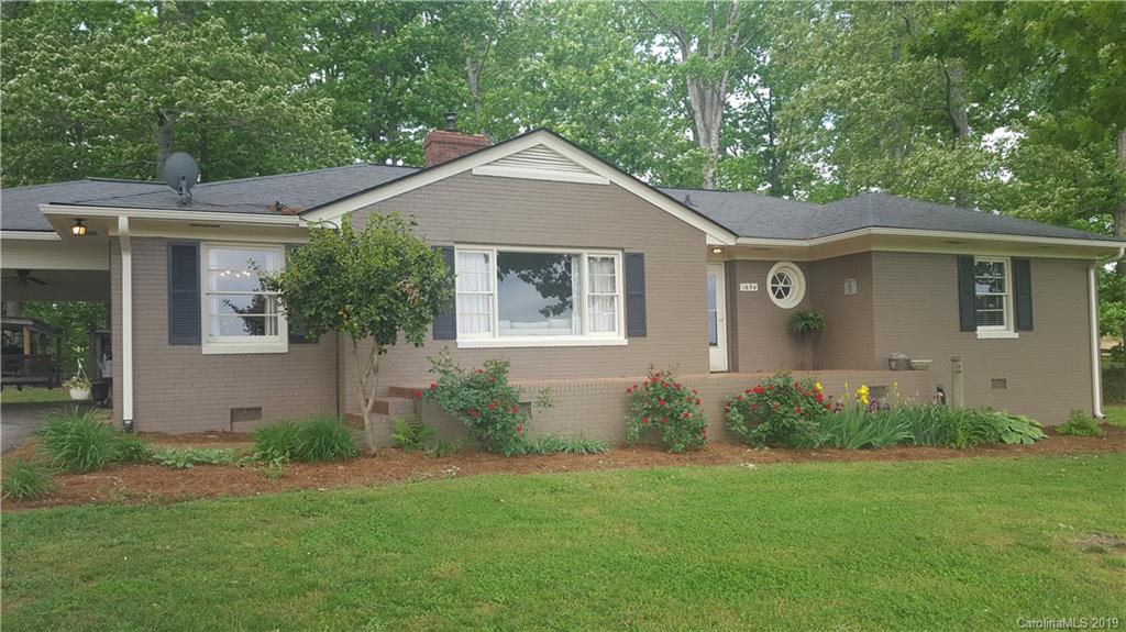 1654 Prince Road Columbus, NC 28722 - Photo 22 of 29 a front view of a house with garden