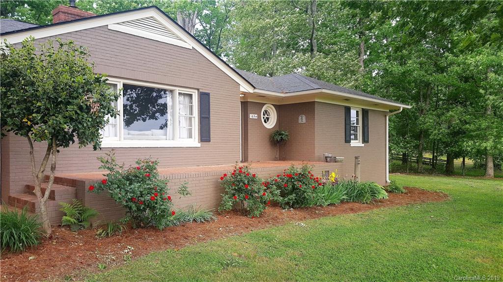 1654 Prince Road Columbus, NC 28722 - Photo 23 of 29 a front view of a house with garden