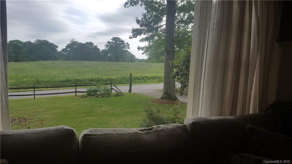 1654 Prince Road Columbus, NC 28722 - Photo 9 of 29 a view of a green field with trees in the background