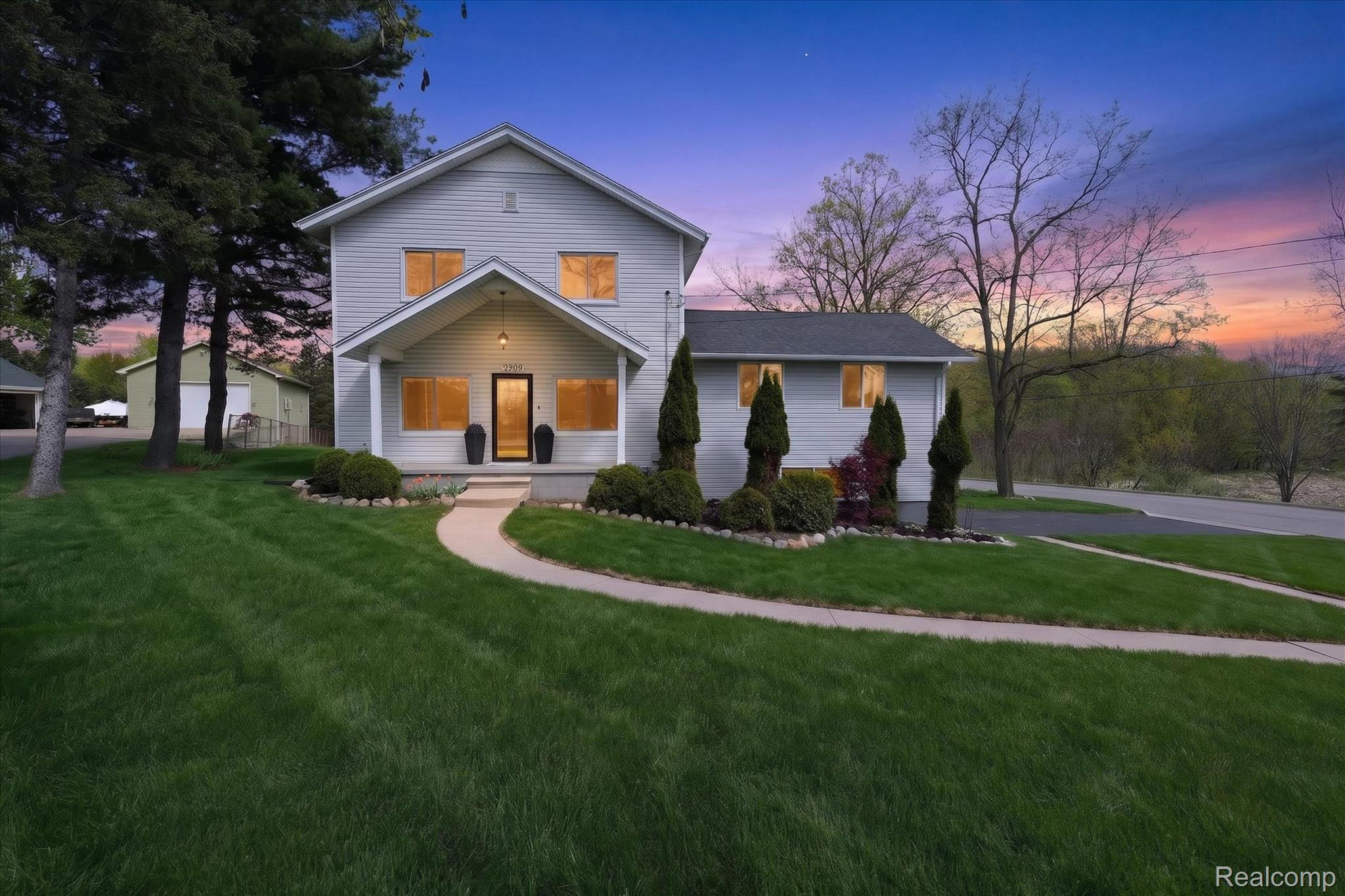 12409 Fenton Road Fenton, MI 48430 - Photo 54 of 61 View of front facade featuring a porch and a front yard
